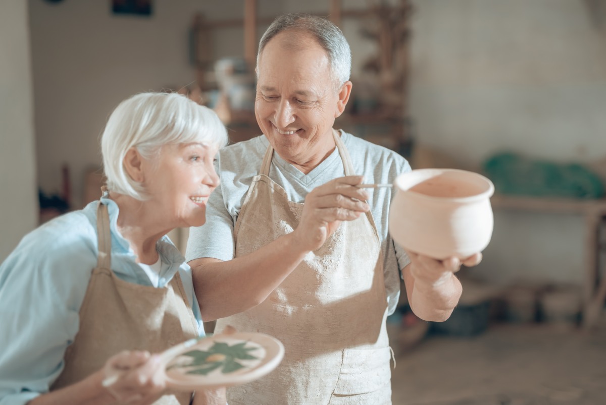 Town Village Crossing | Happy seniors working with clay