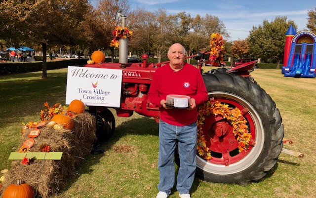 Town Village Crossing | Senior man in front of tractor