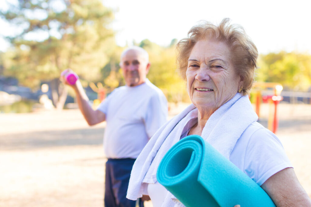 Pegasus Senior Living | Seniors doing group activities with yoga mat and small weights