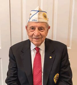 Town Village of Leawood | Senior names Mike wearing a suit and a sailor cap