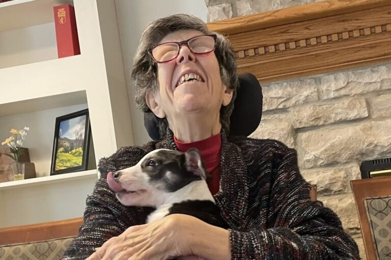 Town Village of Leawood | Resident hugging a dog