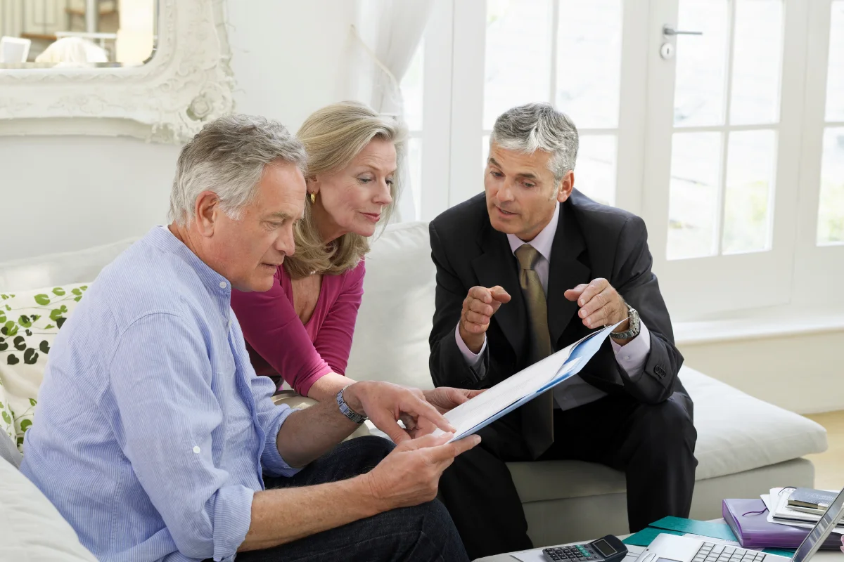 Senior couple discussing finances with team member