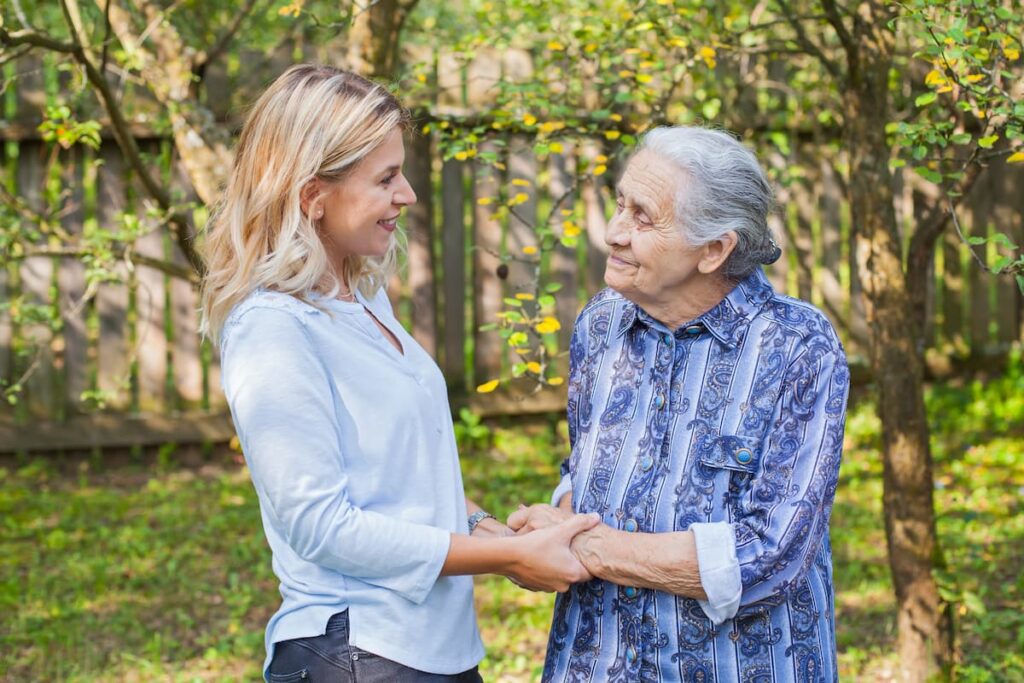 Pegasus Senior Living | Learning about dementia - senior woman with caregiver outside together