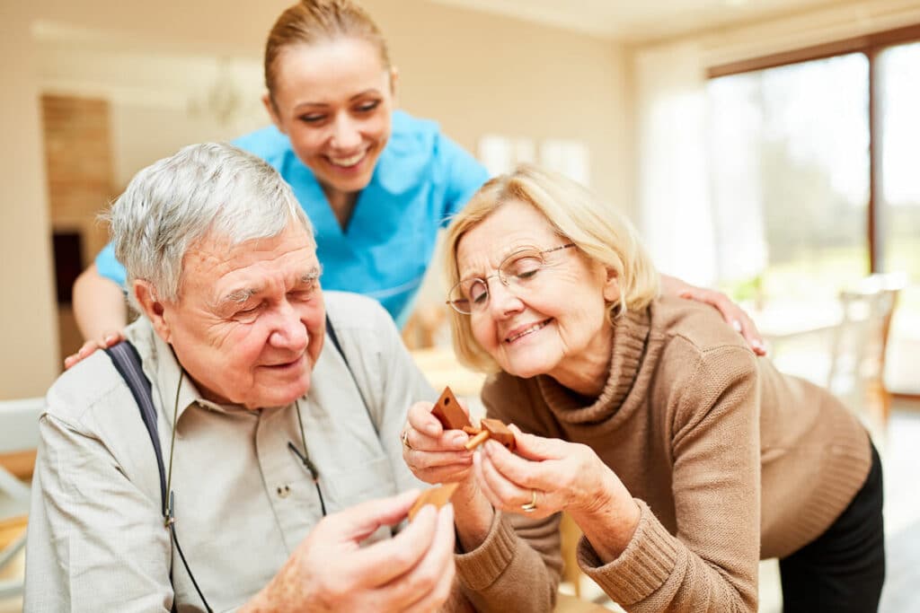 Whispering Winds of Apple Valley | Caregiver assisting seniors with memory care activities