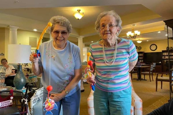 Whispering Winds of Apple Valley | Seniors playing with fishing crafts