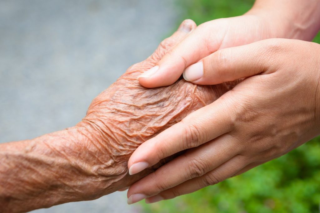 Pegasus Senior Living | Senior holding hands with caregiver