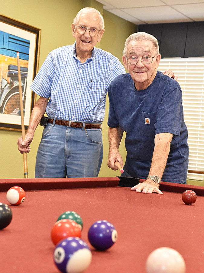 two senior men playing pool at a Pegasus Senior Living community