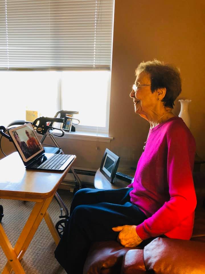 Pegasus Senior Living | Resident video chatting with family