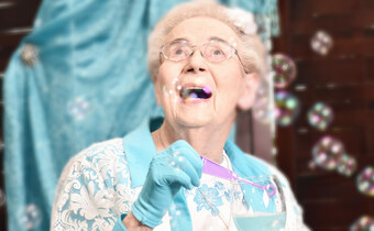 Pegasus Senior Living | Resident blowing bubbles