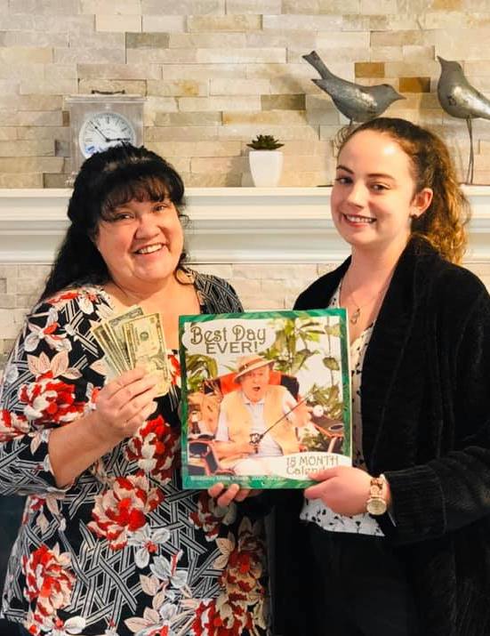 Pegasus Senior Living | Teresa Hadley holding book with other associate