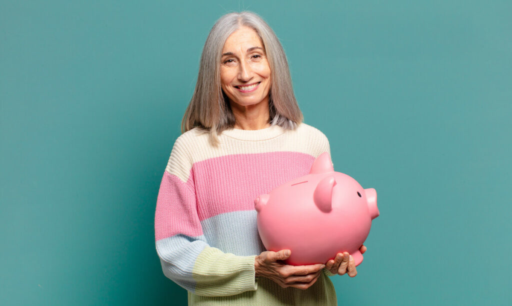 The Rivers at Puyallup | Senior Holding a Piggy Bank