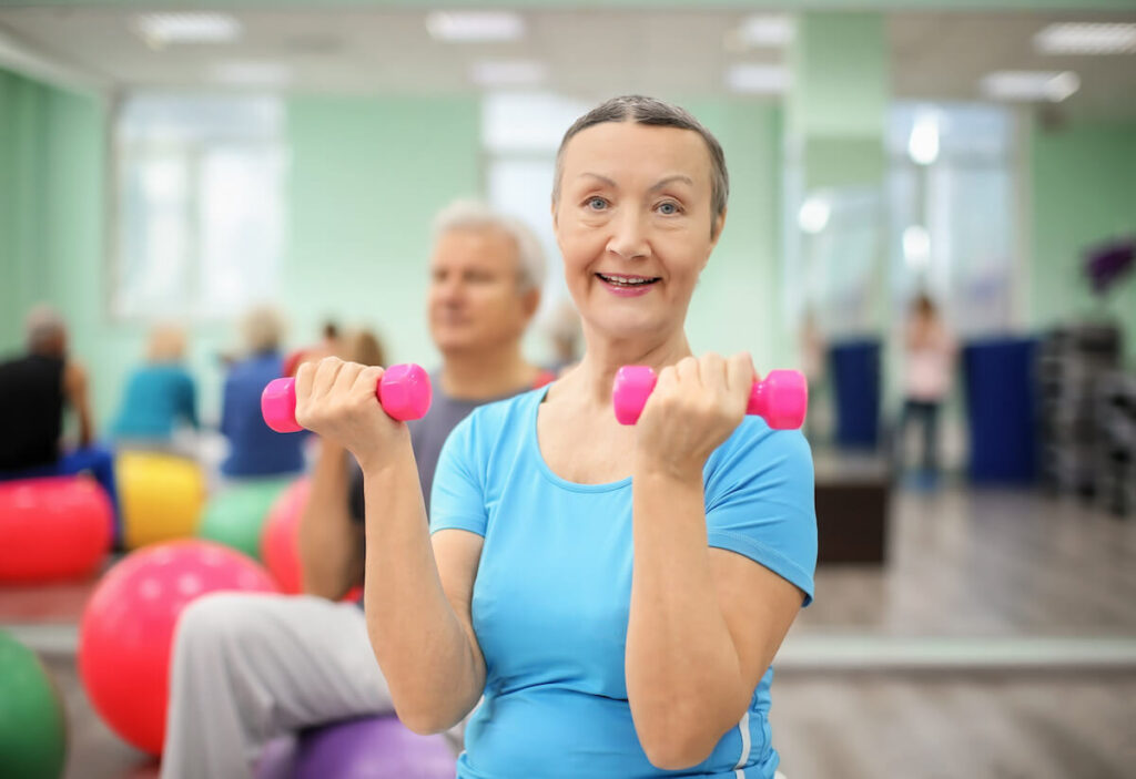 Pegasus Senior Living | Seniors participating in group exercises with  small light weights