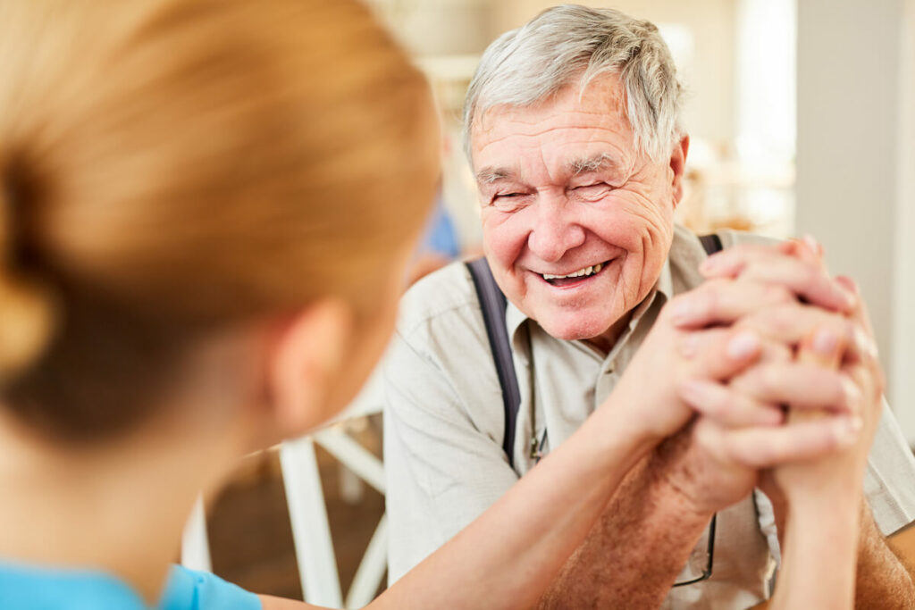 Pegasus Senior Living | Caregiver providing support to happy senior