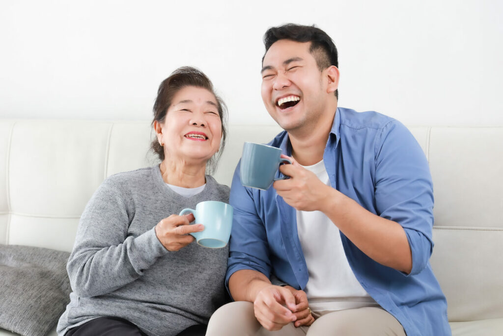 Pegasus Senior Living | Happy senior drinking coffee with family member