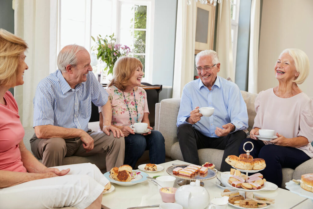 Dunwoody Place | Group of happy seniors enjoying pastries and coffee together