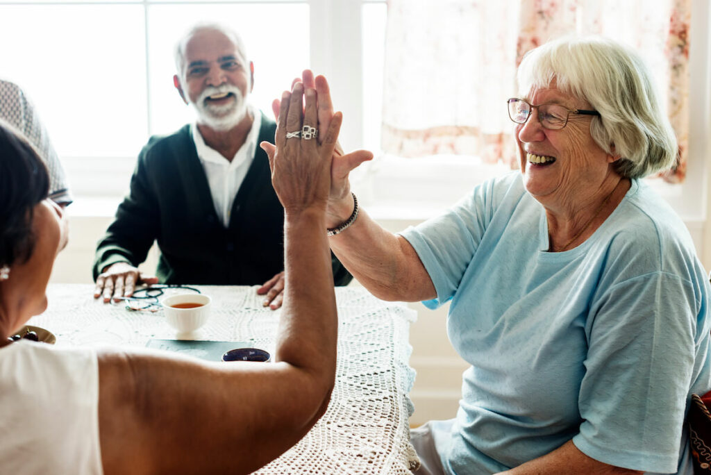 The Farrington at Tanglewood | Happy seniors high-fiving each other