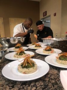 Pegasus Senior Living | Cooks working together to plate food