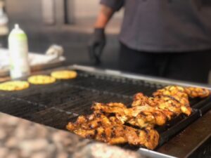 Pegasus Senior Living | Chicken cooking on a grill