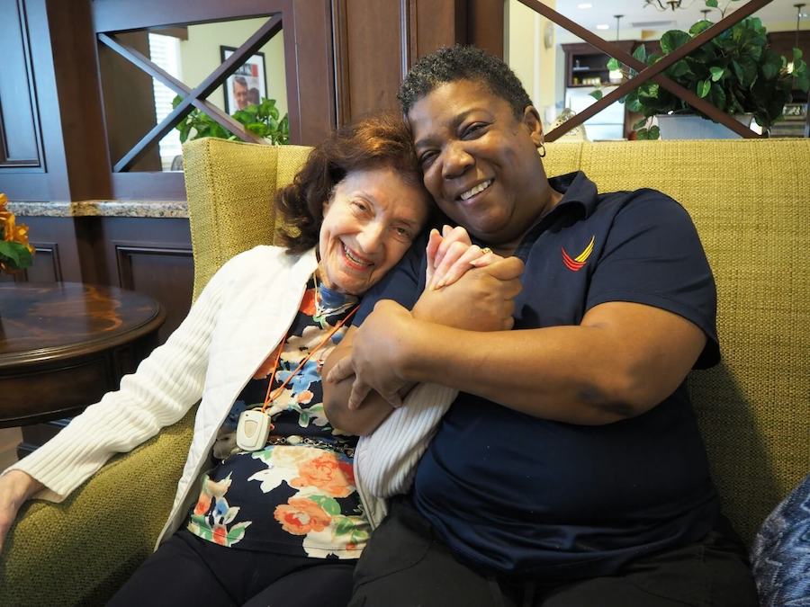 Pegasus Senior Living | Resident and caregiver together smiling