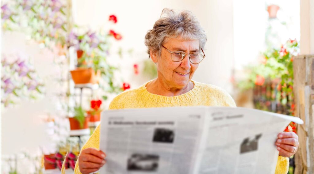 Pegasus Senior Living | Senior reading the newspaper