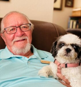 Pegasus Senior Living | Lilly, a small white and black dog with her owner, Richard