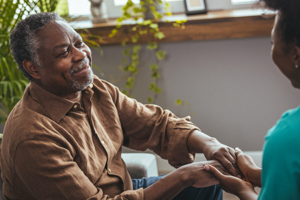 Pegasus Senior Living | Happy senior man holding hands with his wife