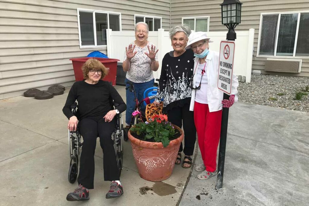 North Point Village | Four senior woman smiling during gardening day