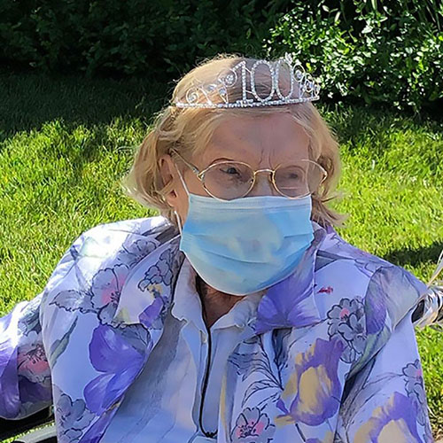 Pegasus Senior Living | Centenarian, Elouise, wearing a tiara that says 100