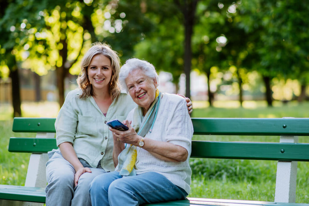 Dunwoody Place | Happy senior outdoors with caregiver