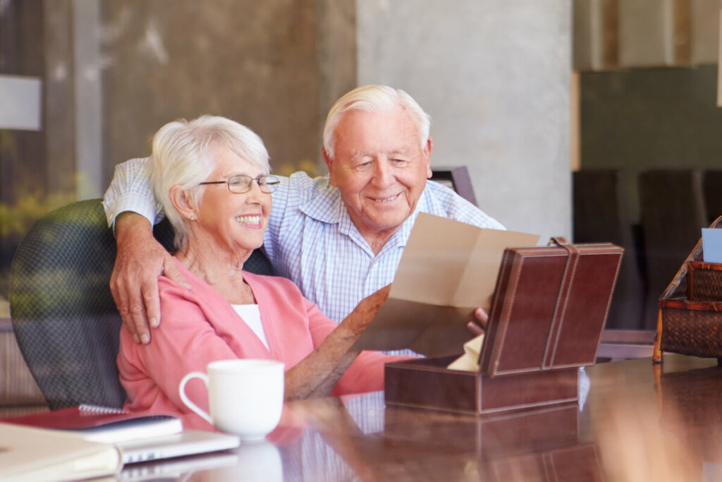 Belleview Suites at DTC | Happy senior couple looking at memory box