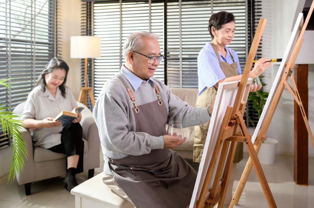 The Courtyards at Mountain View | Seniors painting together in the activity room