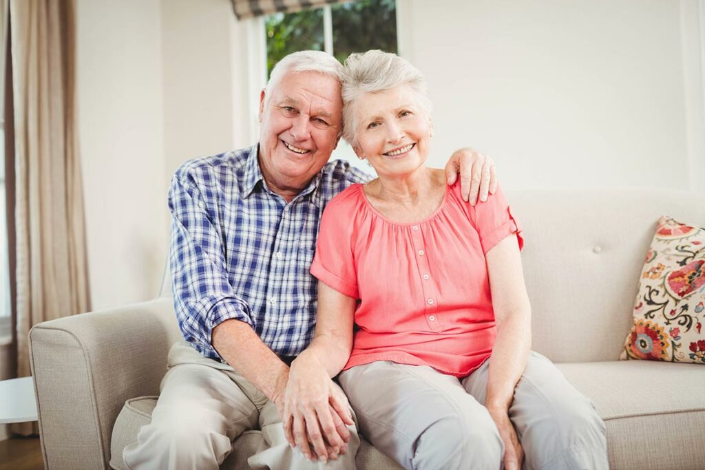 Historic Roswell Place | Happy senior couple sitting on couch