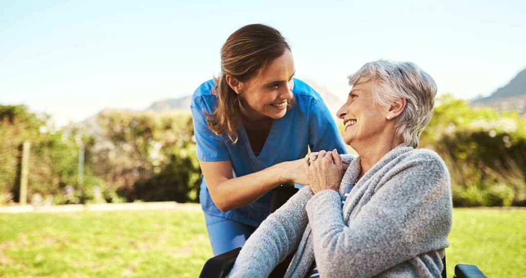 Creston Village | Caregiver helping senior woman outside