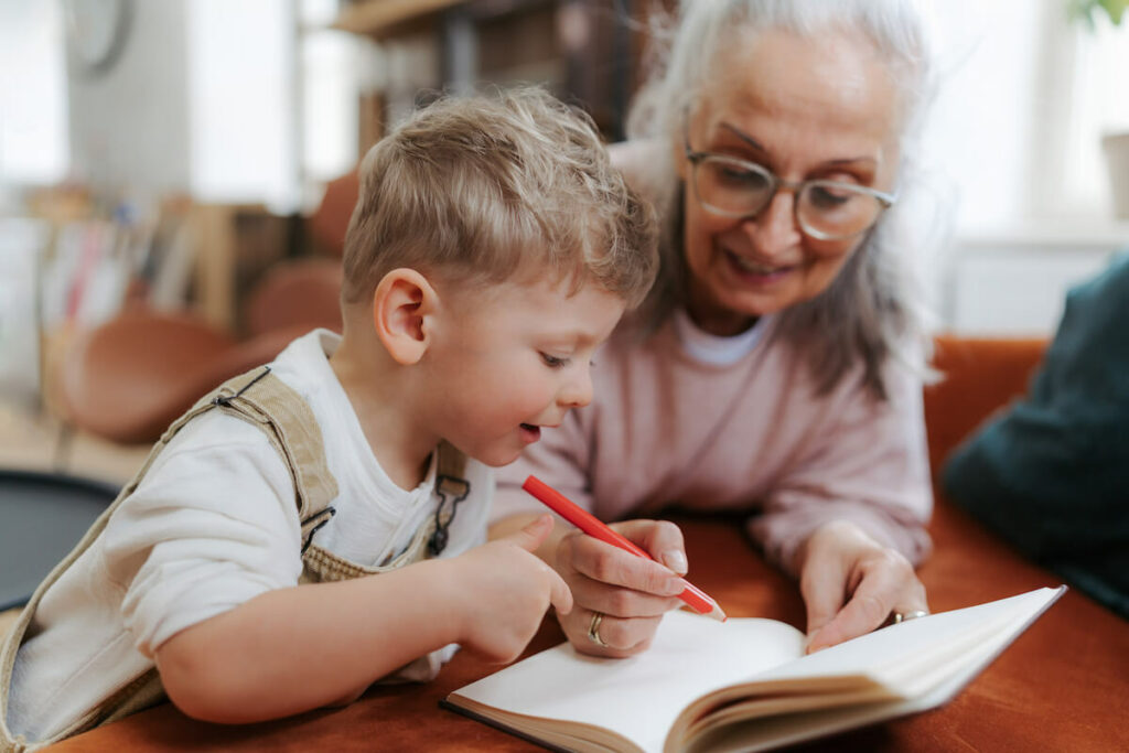 Creston Village | Senior woman drawing and coloring with her grandchild