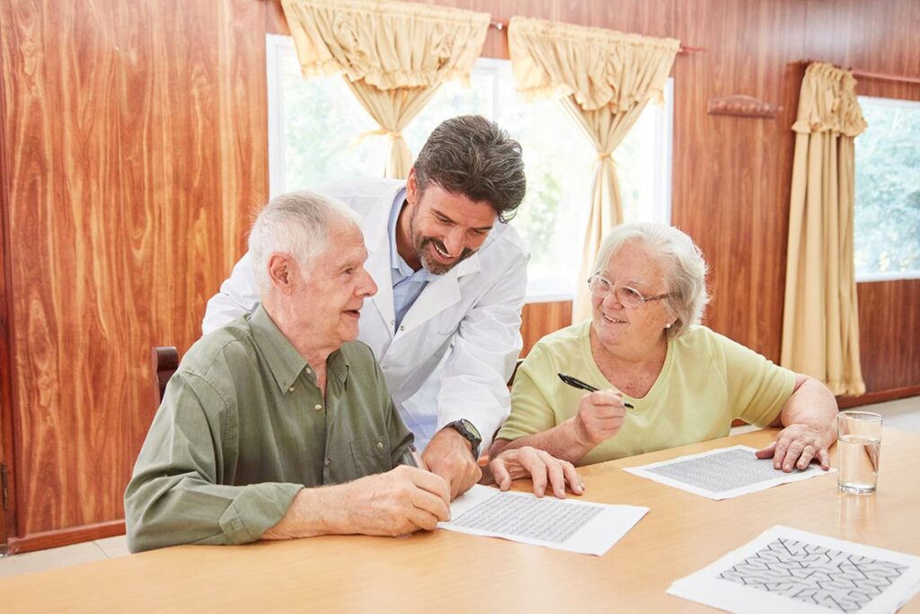 Tucson Place at Ventana Canyon | Nurse helping seniors solve puzzle
