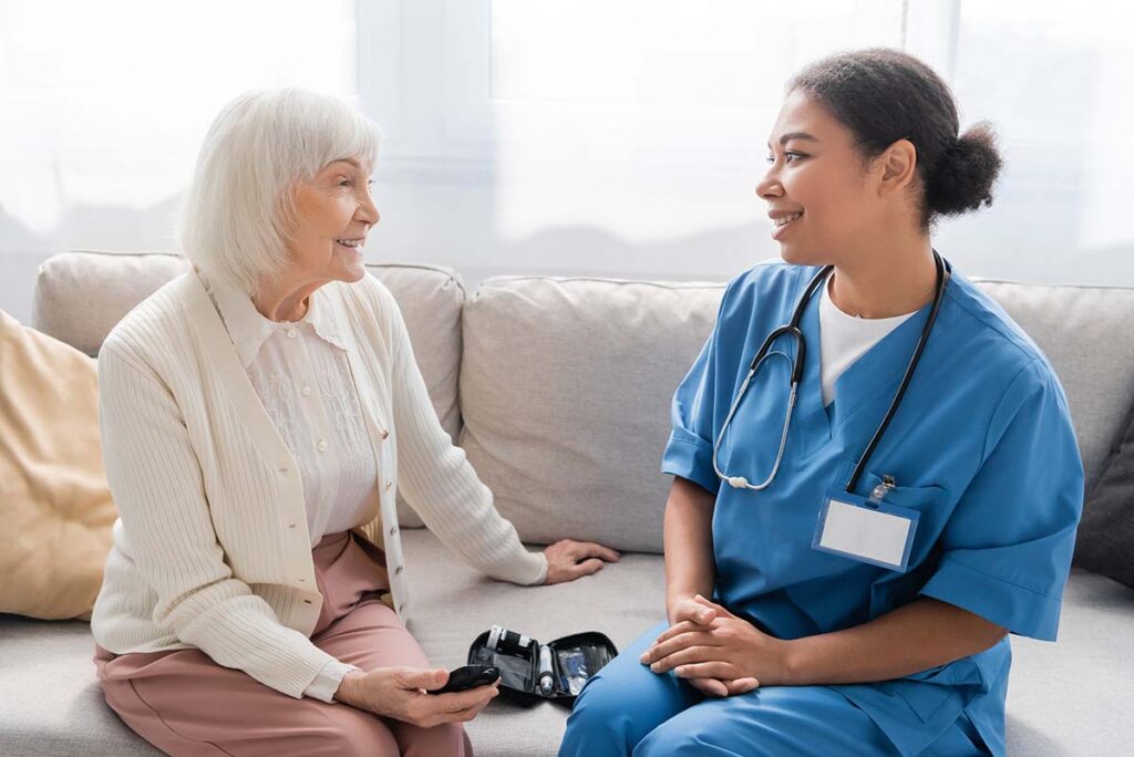 Belleview Suites at DTC | Happy senior woman talking with her caregiver about memory care in Denver