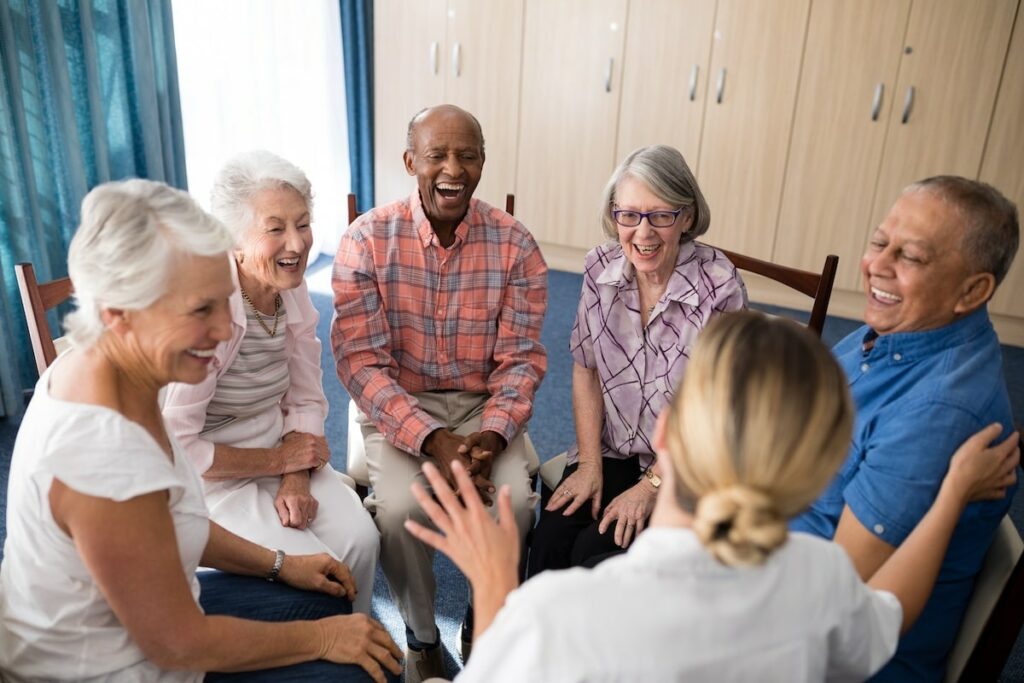 Creston Village | Cheerful seniors sitting as a group