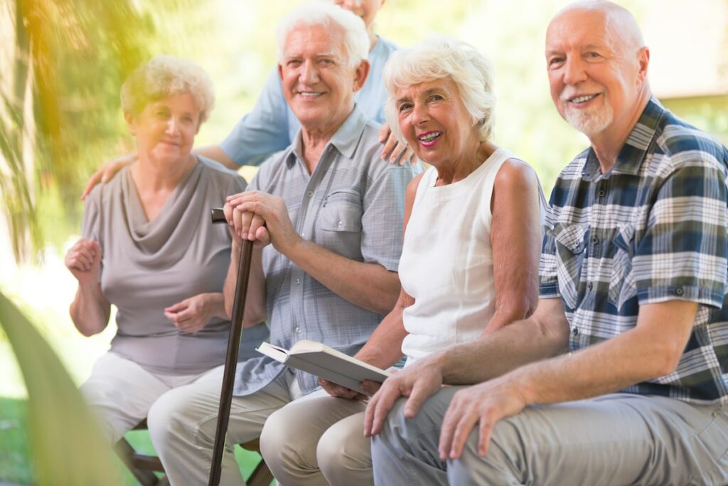 Greenhaven Place | Happy seniors sitting outside