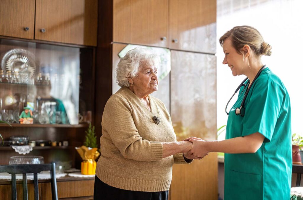 Whispering Winds of Apple Valley | Caregiver talking to a senior woman during home vist