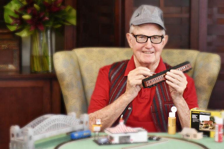 Broadway Mesa Village | Smiling senior man crafting
