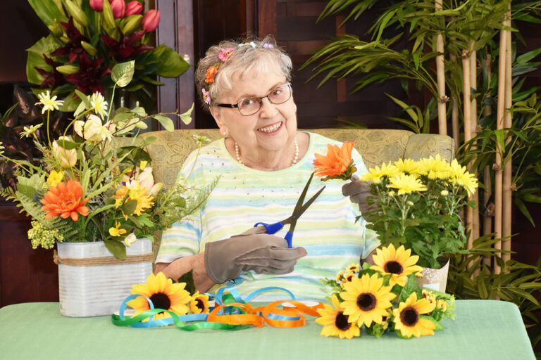 Broadway Mesa Village | Senior woman creating floral crafts