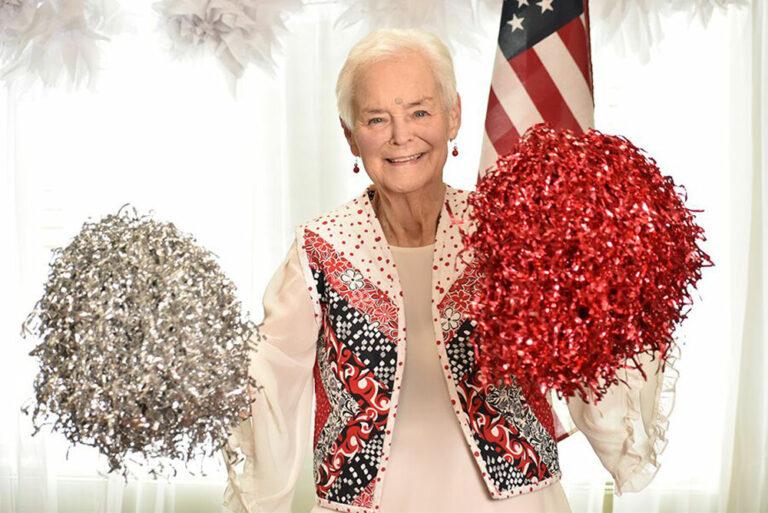 Broadway Mesa Village | Senior woman with pom-poms