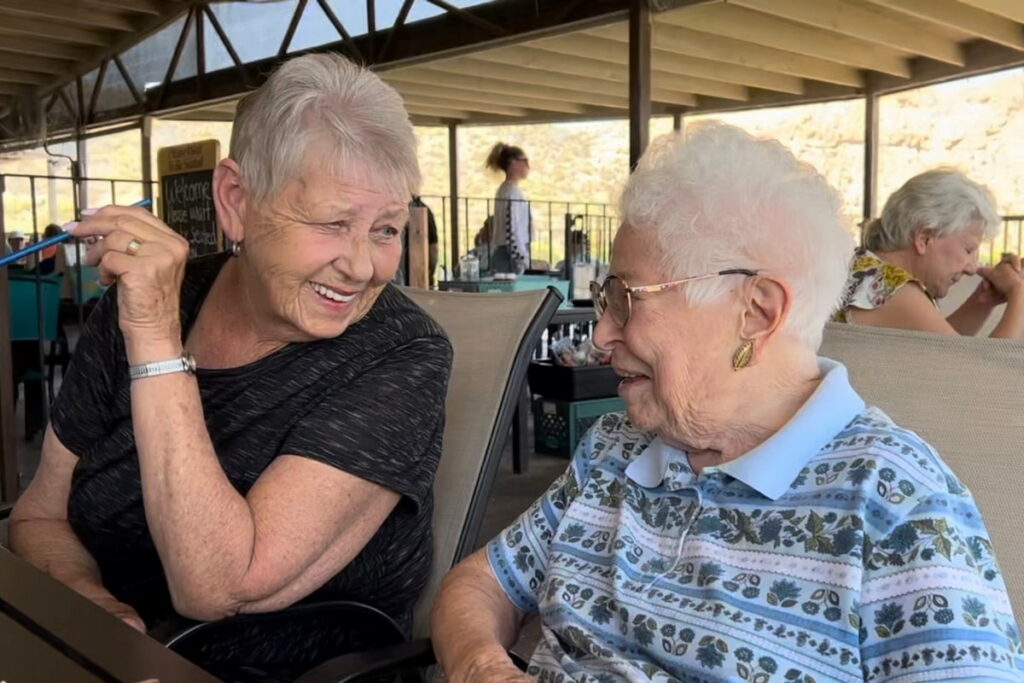 Broadway Mesa Village | Volunteer laughing with resident