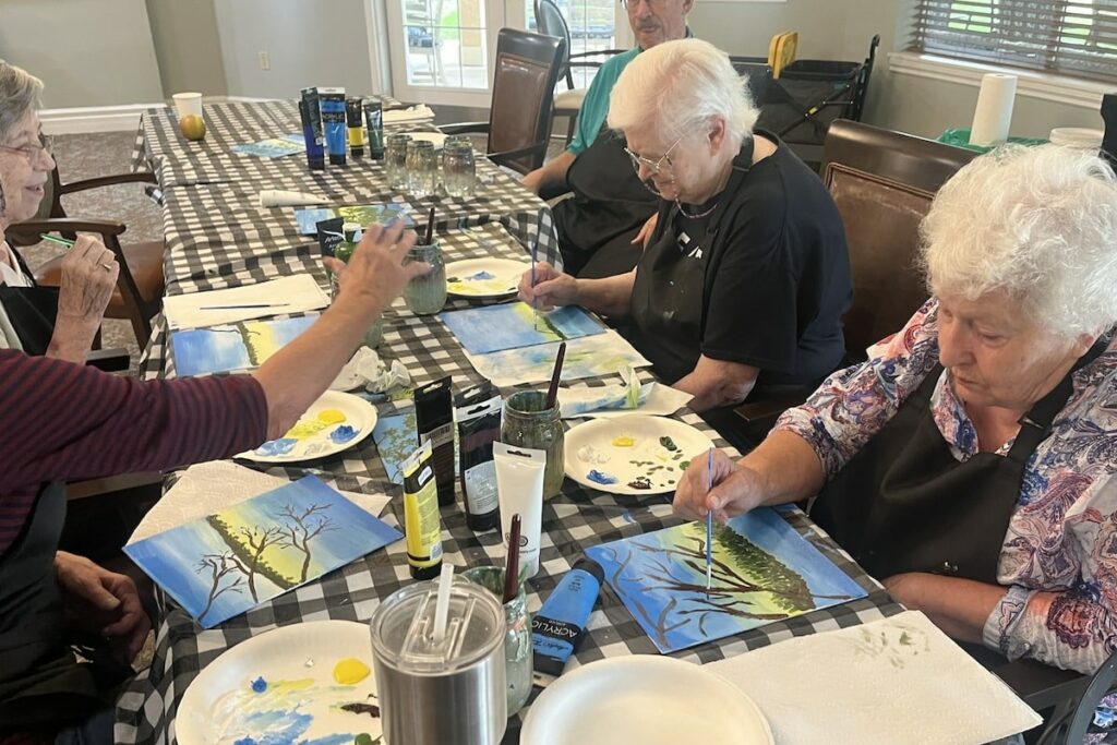 The Courtyards at Mountain View | Seniors painting in an assisted living