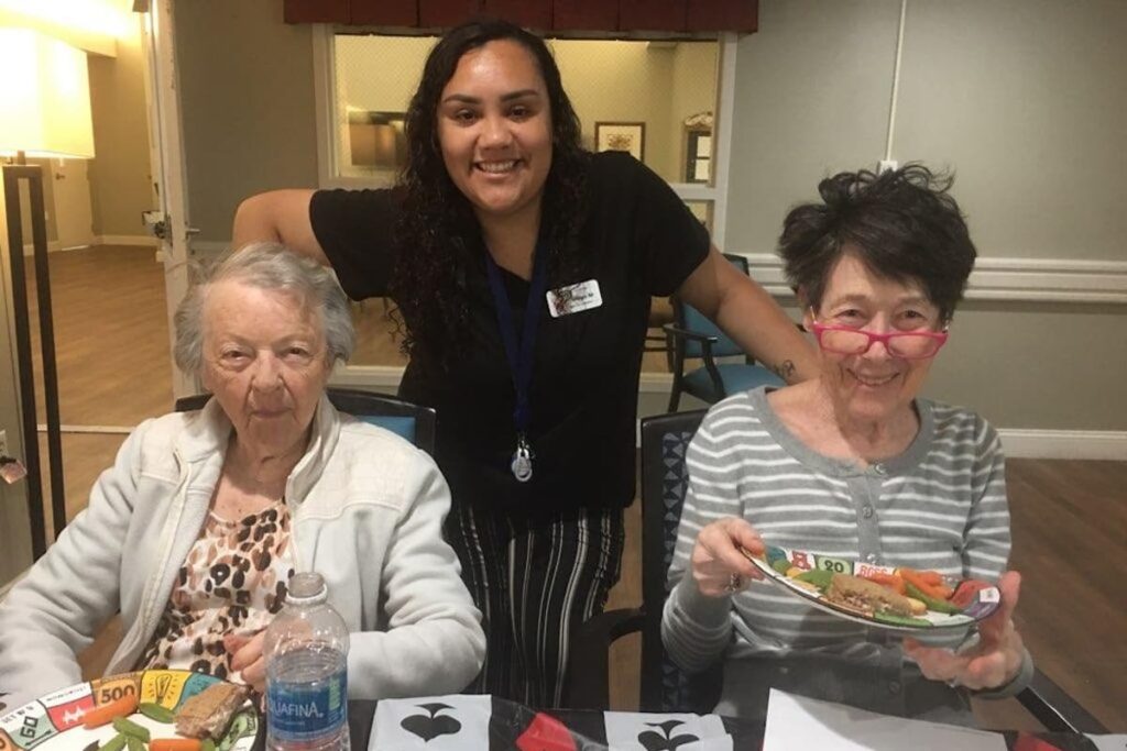 The Village at Rancho Solano | Team member and residents enjoying a meal