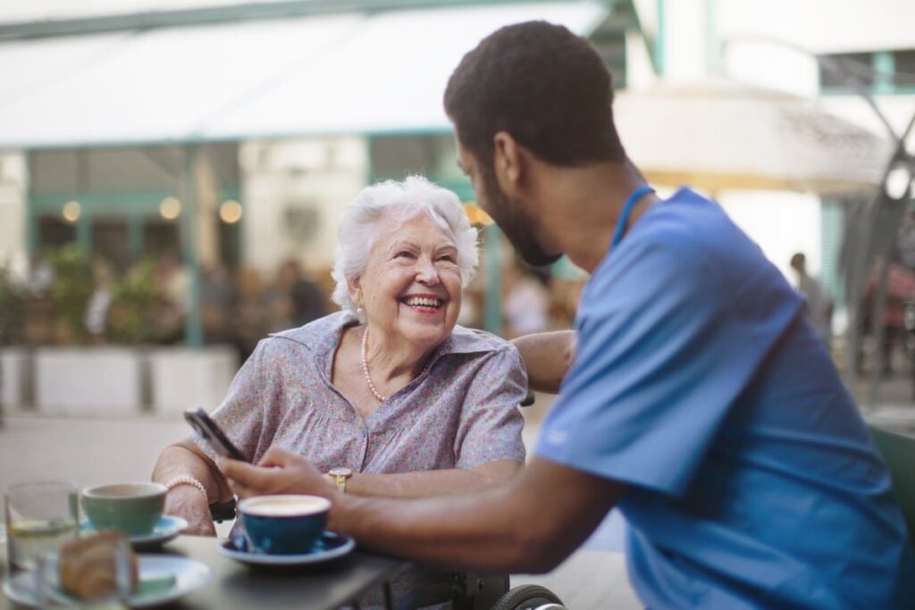Pegasus Senior Living | Senior woman eating breakfast with a caretaker